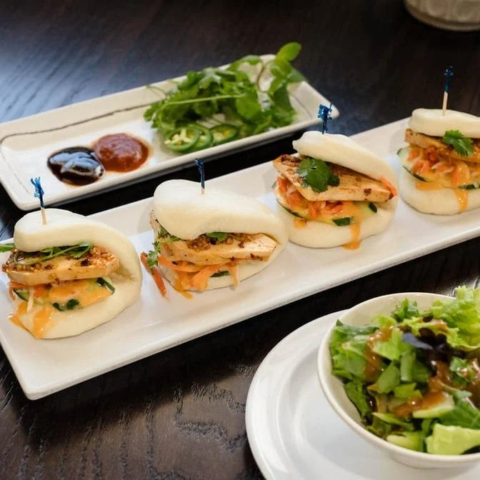 Steamed Bao Buns (Bao Tacos) with pork and pickled vegetables.